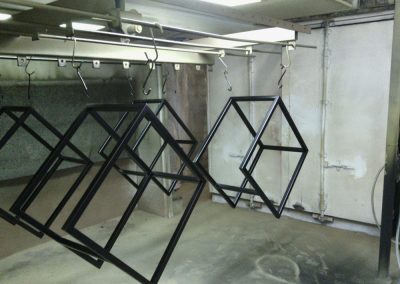 Framework that has been abrasive blasted and powder coated hanging to dry