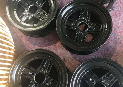 Set of mag wheels that have been abrasive blasted undercoated and then powder coated black