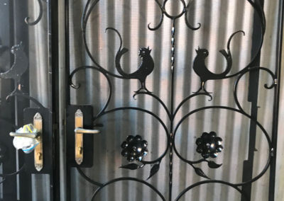 A set of 4 ornate gates which have been restored, which included abrasive blasting, undercutting and powder coating the gates and the fly screens, and hand polishing the locks