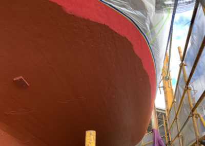 The hull of the One and All Tall ship after the first undercoat had been partially painted