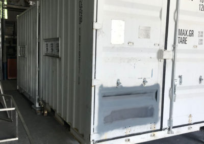 Shipping containers that have been converted to communication centres for the Australian which are being prepared for respraying