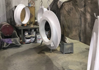 Huge cross country gas pipe flanges which have beed sand blasted and undercoated